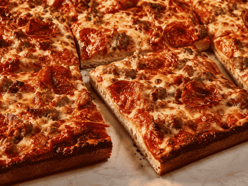 Mama’s Too square pizza slices with crispy crust and pepperoni.